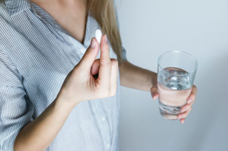 httpswww.pexels.comphotowoman-holding-half-full-glass-and-white-medicine-pill-576831