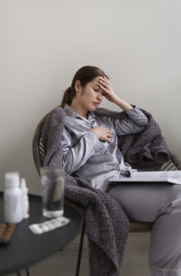 medium-shot-sick-woman-home